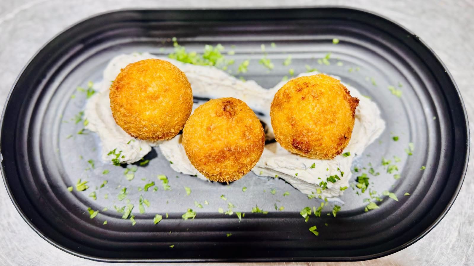 Golden beef arancini on a plate